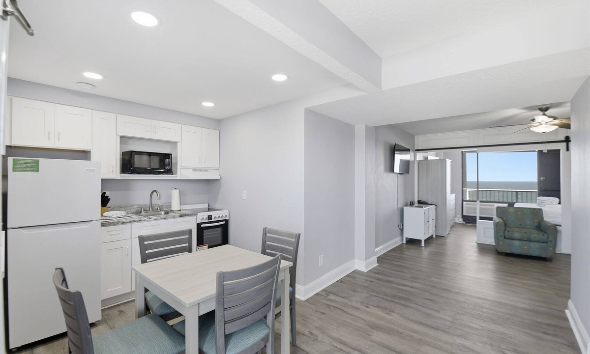 Ormond Beach Apartment | Beachfront Studio | Kitchen + Pool & Picnic Area