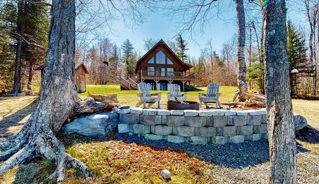 Dog-friendly lakefront cabin with covered porch & firepit on the shore