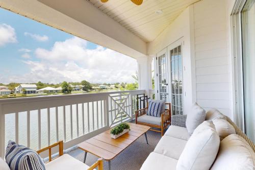 Lakefront condo with water-view balcony private golf cart resort pool & amenities